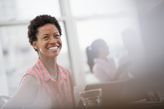 Office Life. A Young Woman In A Pink Shirt Laughing. 
