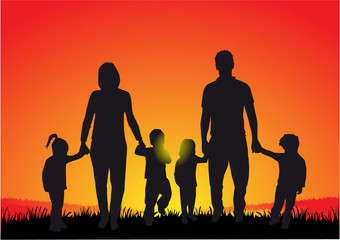 Silhouette of family at sunset .