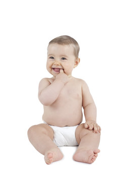 Baby in diaper with finger in mouth isolated on white