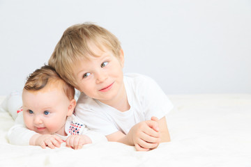 portrait of little boy with newborn sister