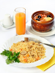 Still life of setout table with soup in ceramic pots, rice and g