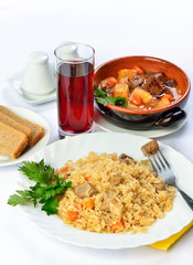 Still life of setout table with soup in ceramic pots, rice and g
