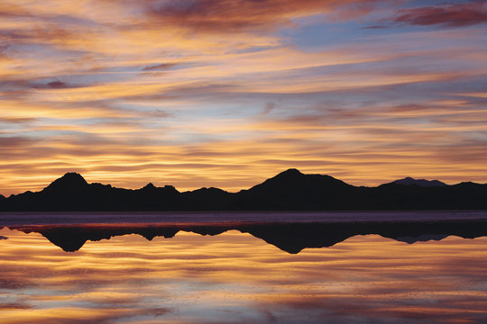 The Sky At Sunset. Layers Of Cloud Reflecting In The Shallow Waters Flooding The Bonneville Salt Flats