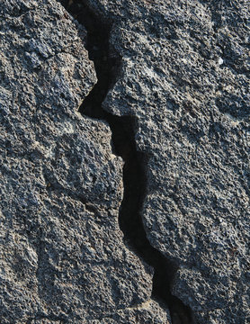 A Lava Field, With Black Solidified Rock Surface, With Fissures. 