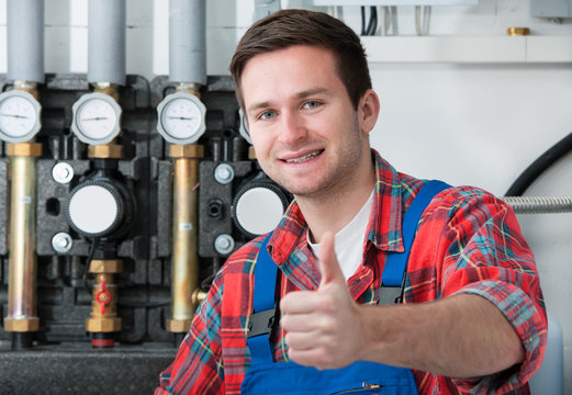 Technician servicing heating boiler