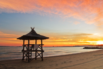Beautiful sunset on the beach and lifeguard station