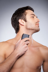 Shaving with electric shaver.
