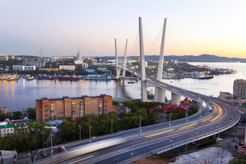 Panorama of evening Vladivostok. Golden bridge. Russia
