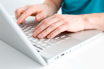 Fototapeta na wymiar Close-up of typing male hands on keyboard