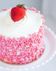 Strawberry cake with white cream on wooden background