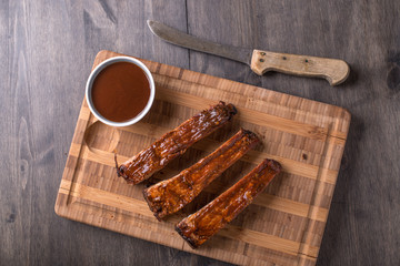 RIbs on a cutting board with BBQ sauce