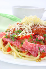 Pasta with salami, paprika, tomato sauce and grated cheese
