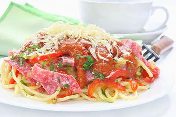 Pasta with salami, paprika, tomato sauce and grated cheese