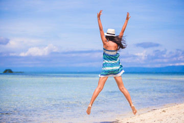 Young beautiful woman jumping in the beach