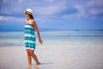 Young woman enjoying the holiday on a white, tropical beach at