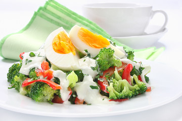 Salad with broccoli,  egg and sauce with yogurt and garlic