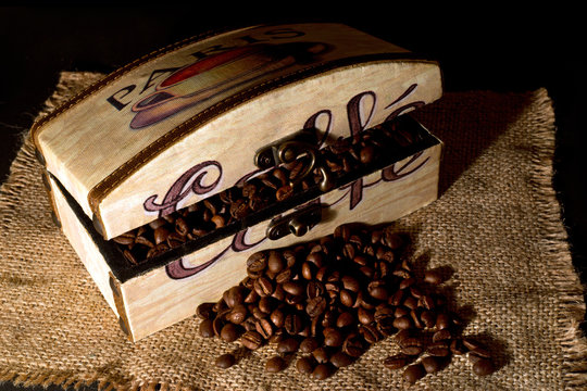 A Wooden Box Filled With Coffee Beans On  Jute Table Cloth