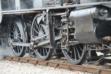 Fototapeta na wymiar The Large Wheels of a Vintage Steam Train Engine.