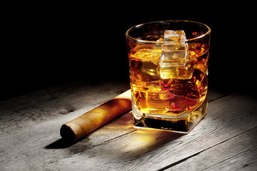Glass of whiskey with a cigar