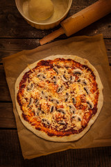 Pizza - dark rustic still life on vintage wood table