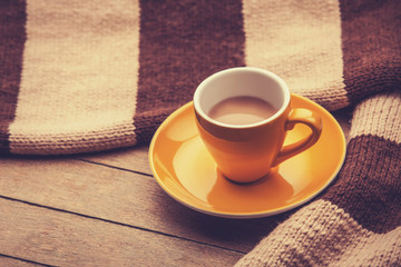 yellow cup of the coffee and vintage scarf.