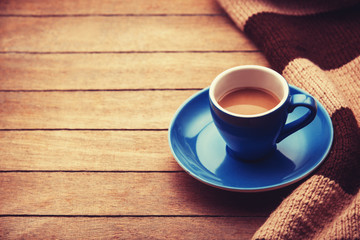 blue cup of the coffee and vintage scarf.