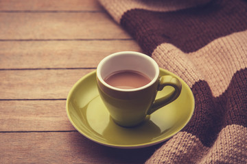 green cup of the coffee and vintage scarf.