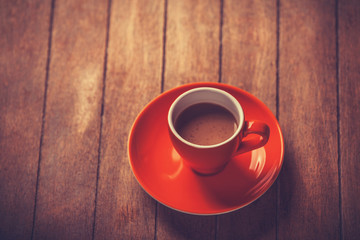 Little cup of the coffee on a wooden table
