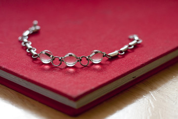 Crystal bead bracelet on a red book