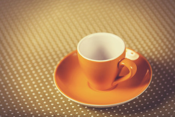 Cup of a coffe on polka dot cover.