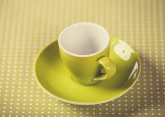 Cup of a coffe on polka dot cover.