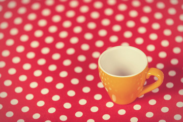 Cup of a coffe on polka dot cover