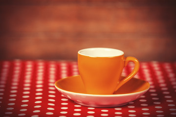 Cup of a coffe on polka dot cover.
