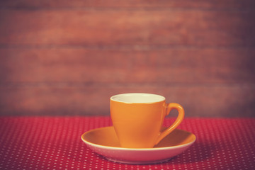 Cup of a coffe on polka dot cover.