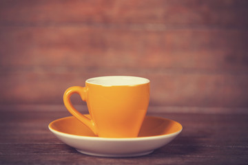 Little cup of the coffee on a wooden table
