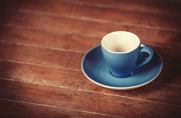 Little and empty cup for a coffeeor tea on a wooden table