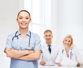 smiling female doctor or nurse with stethoscope