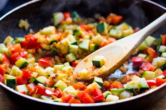 Cooking stew ratatouille from vegetables in frying pan, tasty