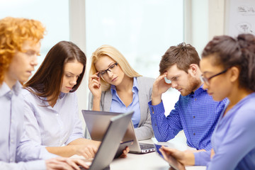 depressed team with laptop and table pc computers