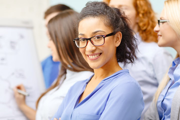 smiling businesswoman with team team on the back