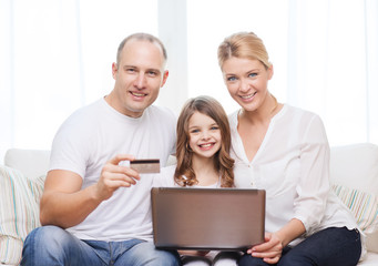 parents and girl with laptop and credit card