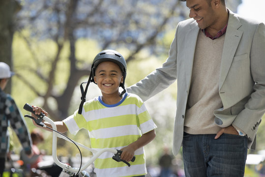Bicycling And Having Fun. A Father And Son Side By Side.