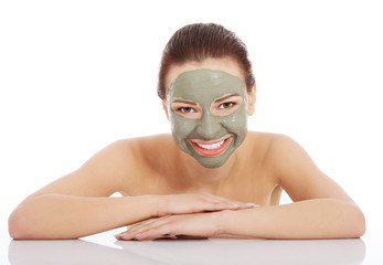 Beautiful woman with clay facial mask