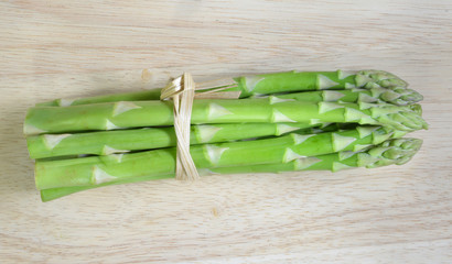 ripe green asparagus on a wooden background