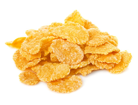 corn flake cereal in a pile isolated against a white background