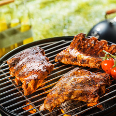 Grilling marinated ribs on a portable BBQ