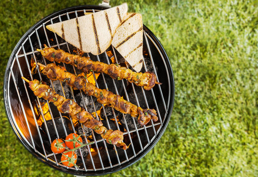 Kebabs grilling on a BBQ fire