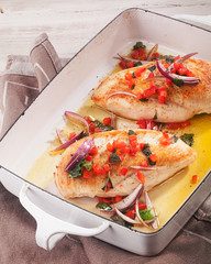 Healthy grilled lean chicken breasts in a pan