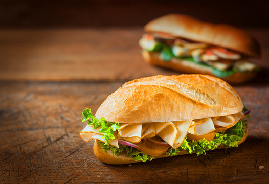 Delicious crusty ham roll on a rustic table