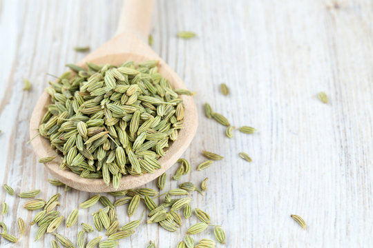 fennel seed in a wooden spoon on table